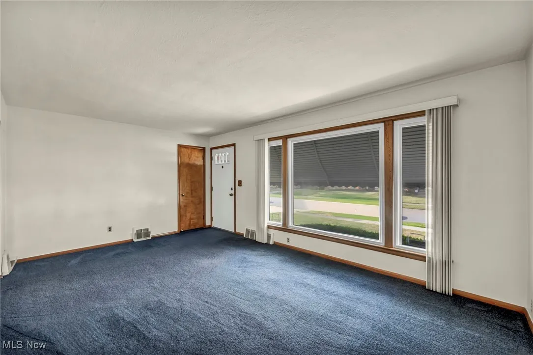 Empty room with carpet flooring