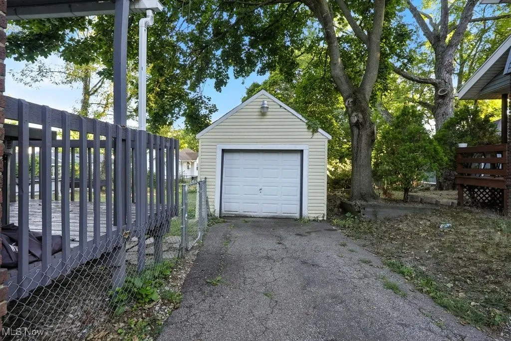 Detached garage with asphalt driveway