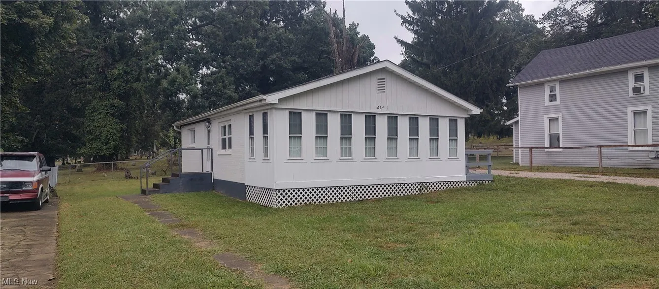 View of front of home featuring view of wooded area