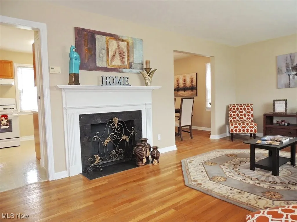 Living area featuring a fireplace with flush hearth and light wood finished floors