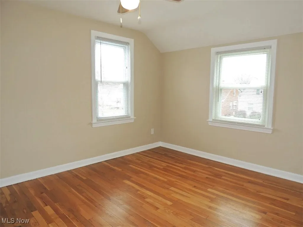 Bonus room featuring hardwood / wood-style flooring, vaulted ceiling, and ceiling fan