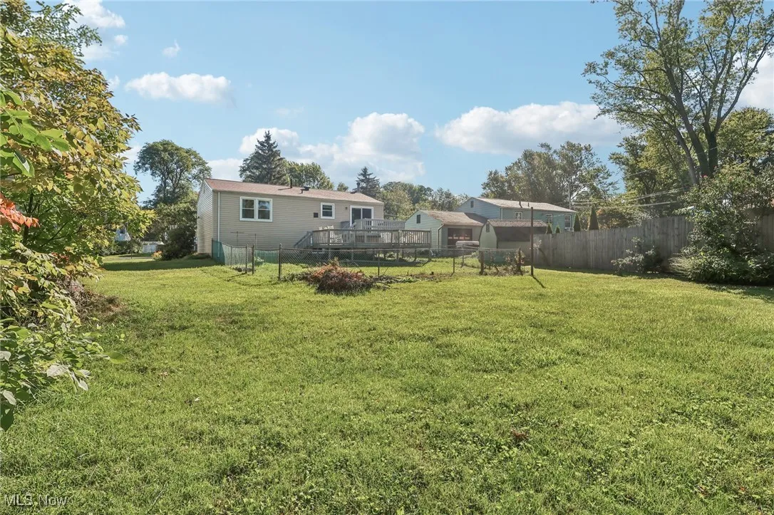 Fenced backyard featuring a wooden deck