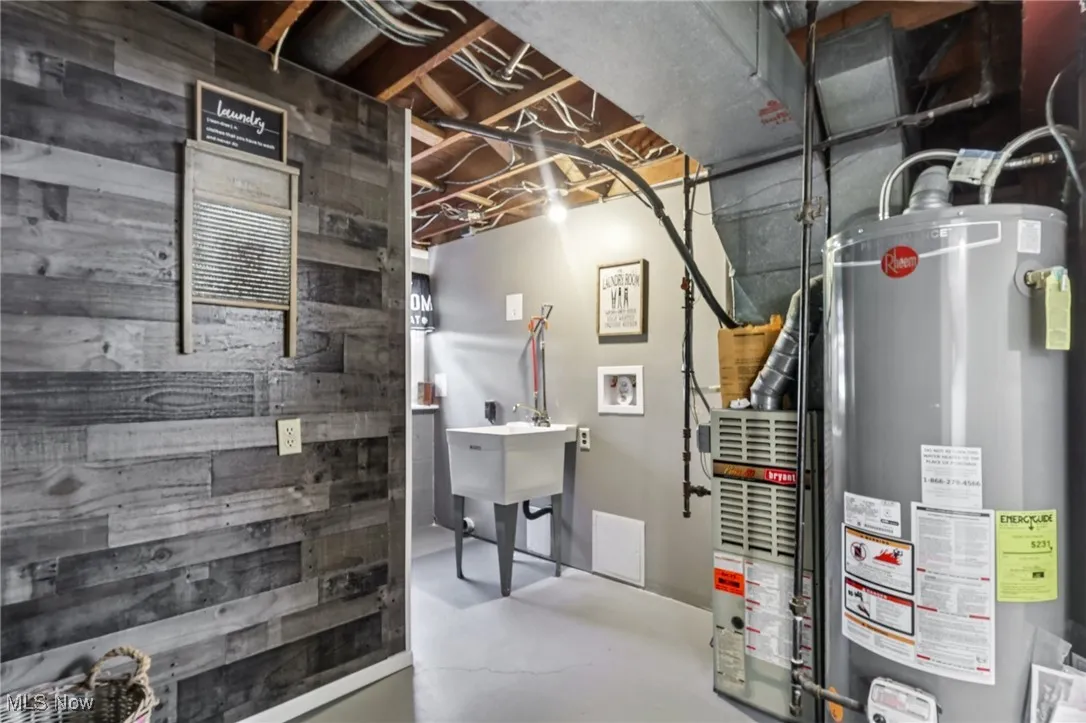 Utility room with gas water heater and heating unit