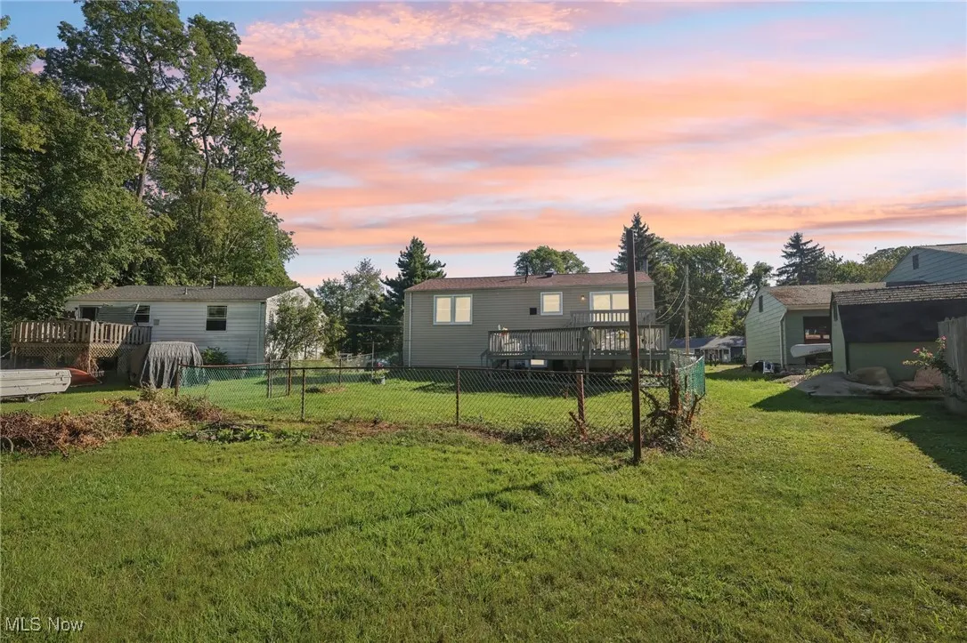 Yard at dusk with a wooden deck