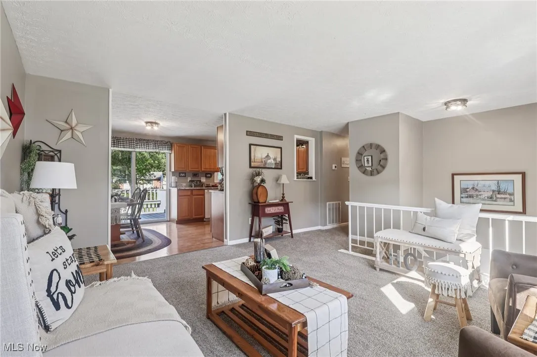 Living room with light carpet and a textured ceiling