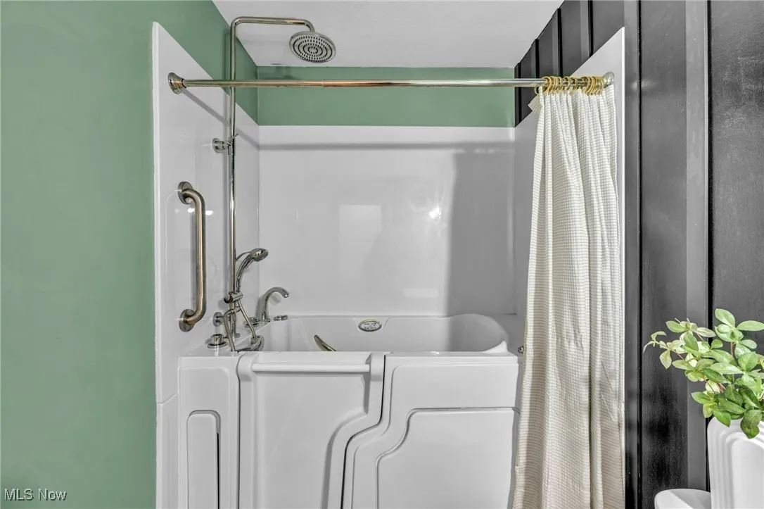 Full bathroom with shower / bathtub combination with curtain