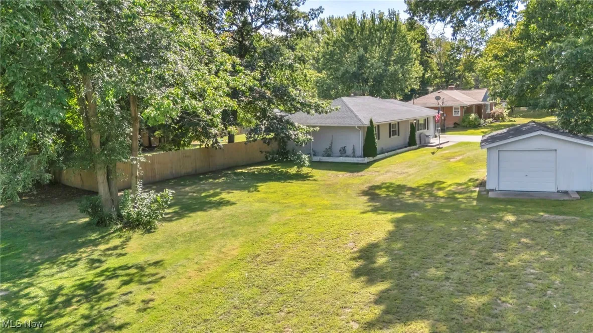 View of yard with an outdoor structure and a garage