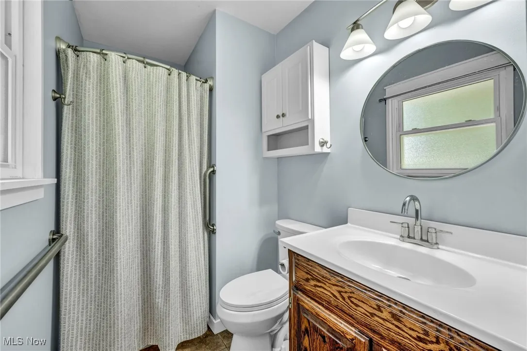 Bathroom featuring vanity and a shower stall