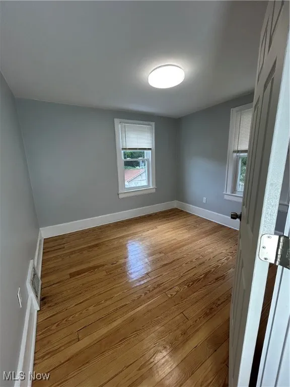 Unfurnished room featuring baseboards and light wood-type flooring