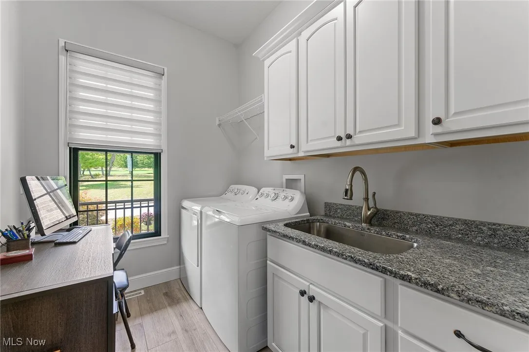 Laundry room with washer, dryer, built-ins and sink.