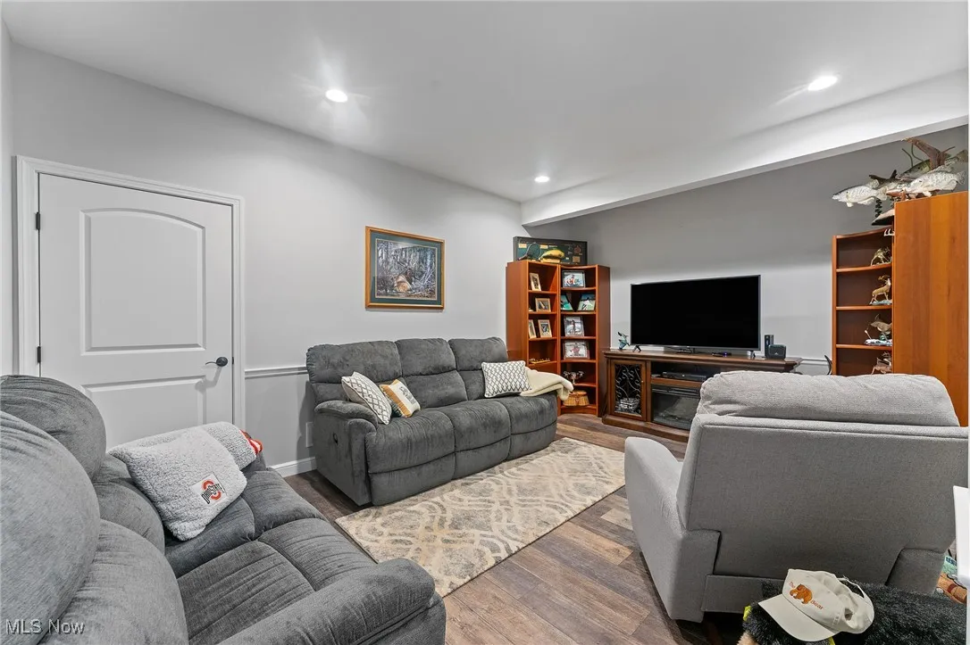 Lower level family room with door to storage and outdoor side entrance.