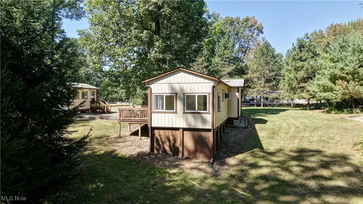 View of outbuilding with view of wooded area
