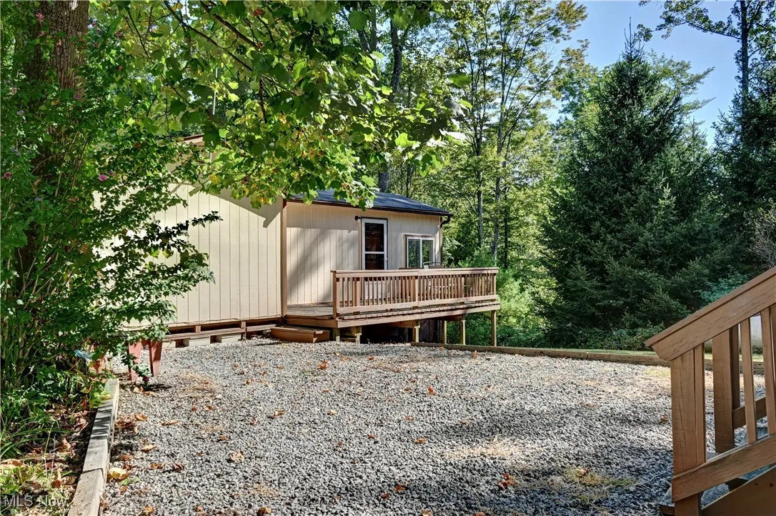 Back of house featuring a wooden deck