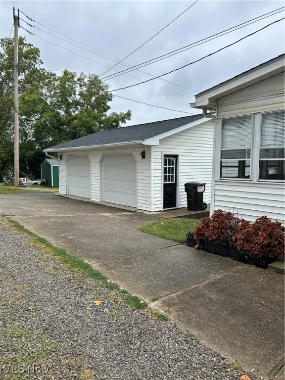 View of side of home with an outbuilding