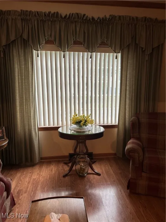 Sitting room with baseboards and wood finished floors