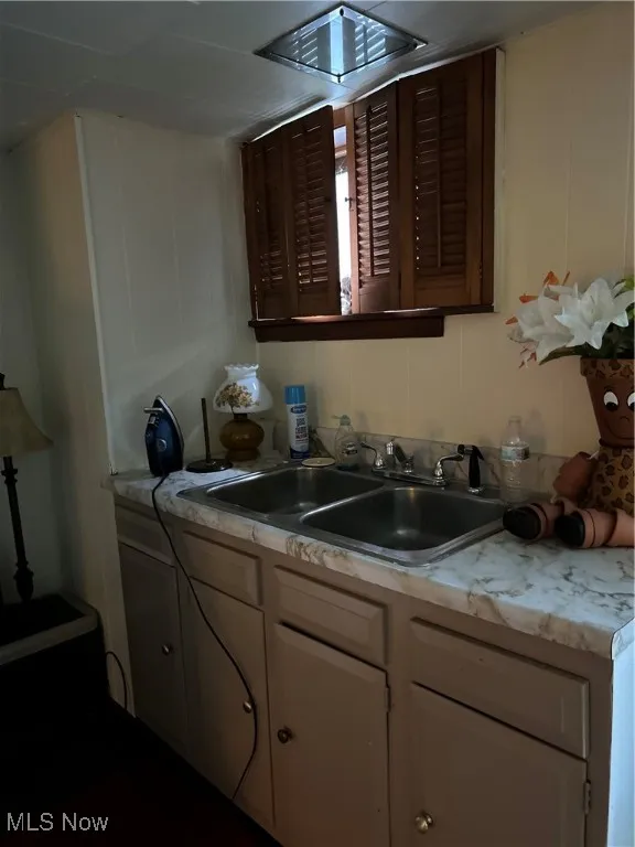 Kitchen with light countertops and a decorative wall