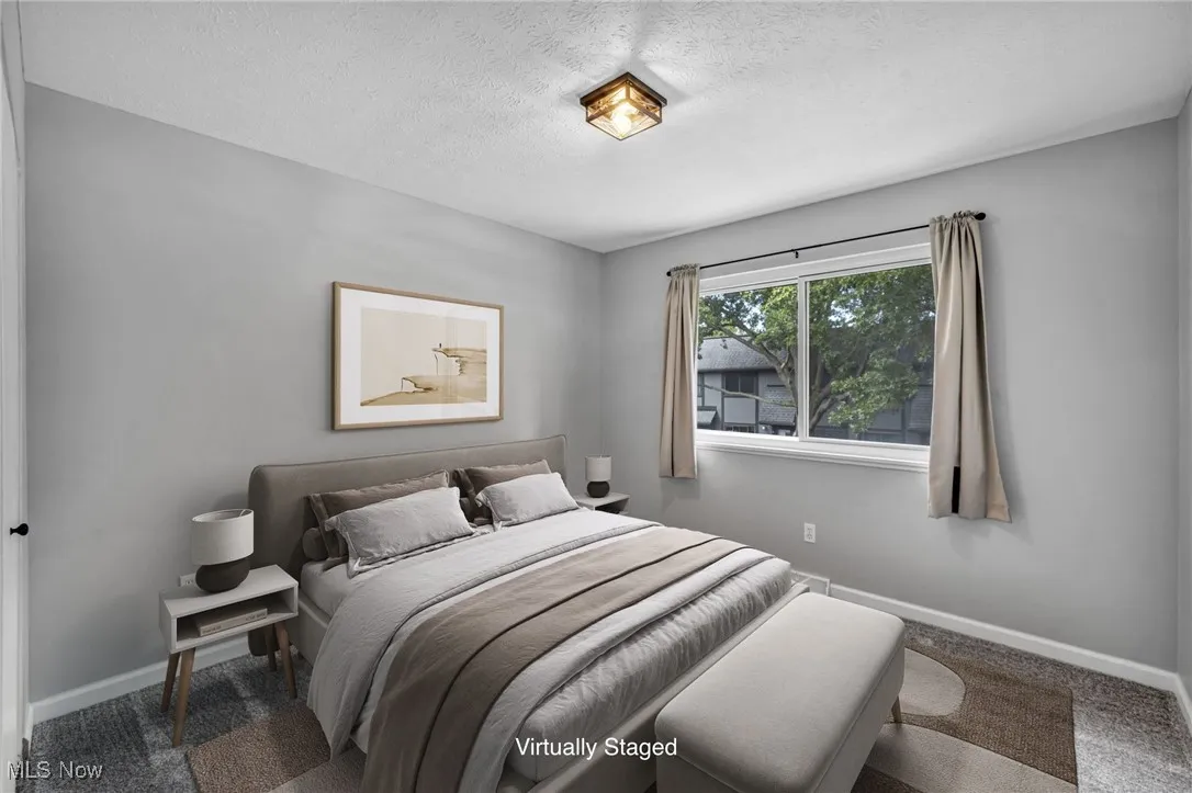 Bedroom featuring carpet flooring and a textured ceiling