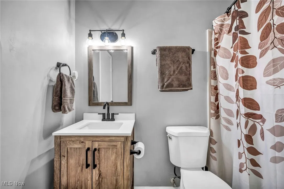 Full bath featuring vanity and a shower with curtain