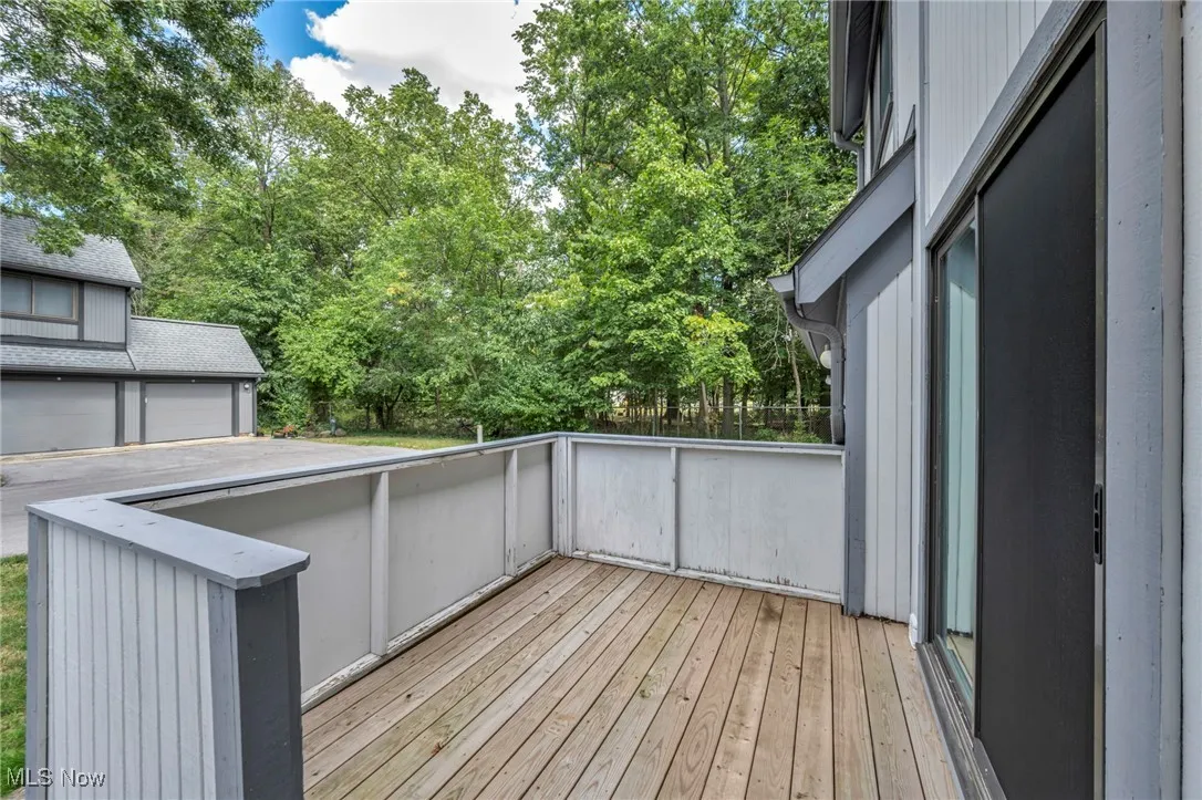 Wooden terrace featuring view of scattered trees