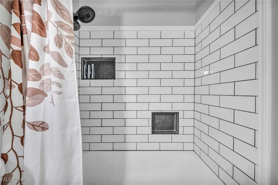 Bathroom featuring shower / bath combo with shower curtain