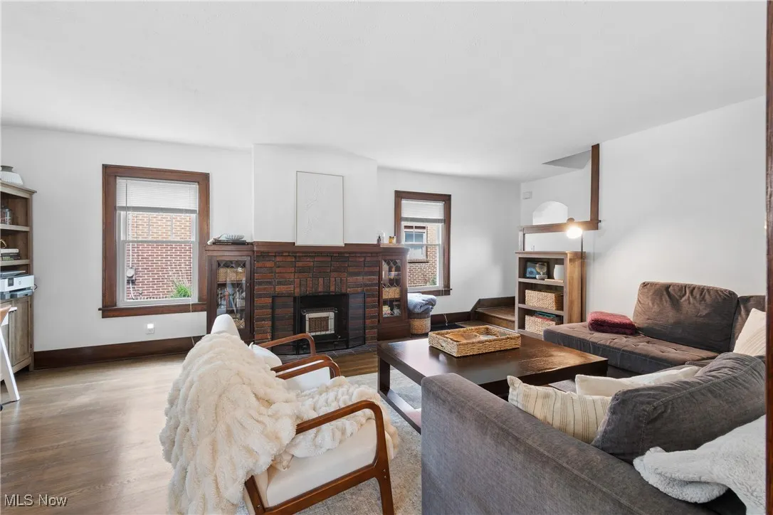 Living room featuring wood finished floors and a fireplace