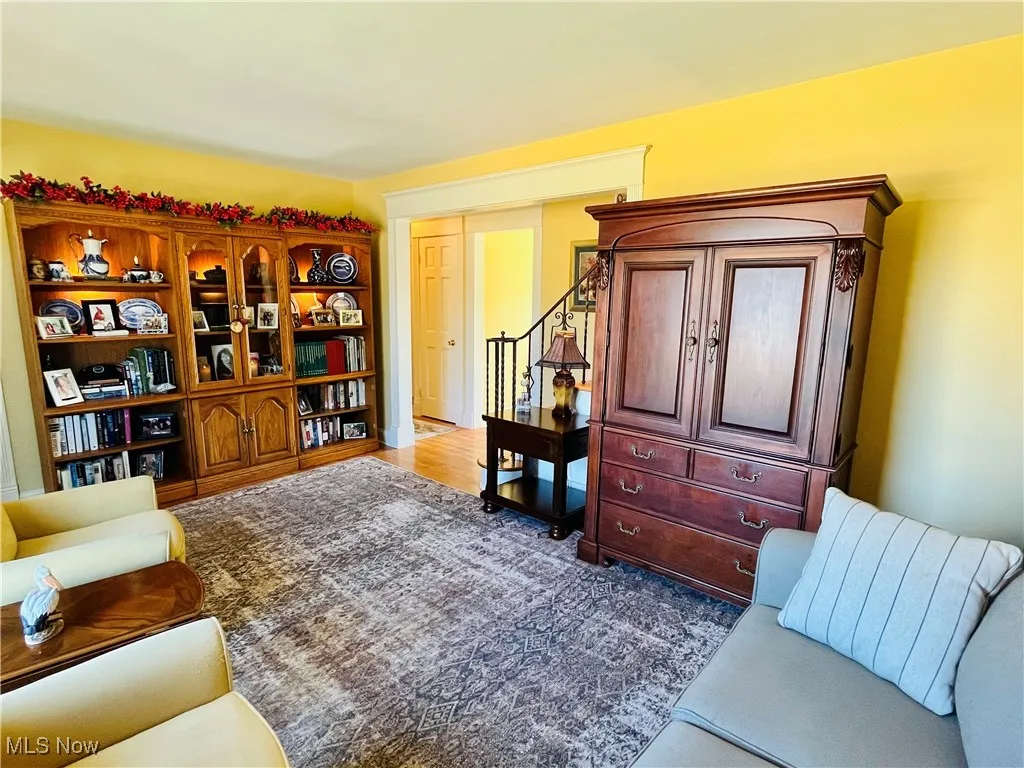 Living area with stairway and dark wood finished floors
