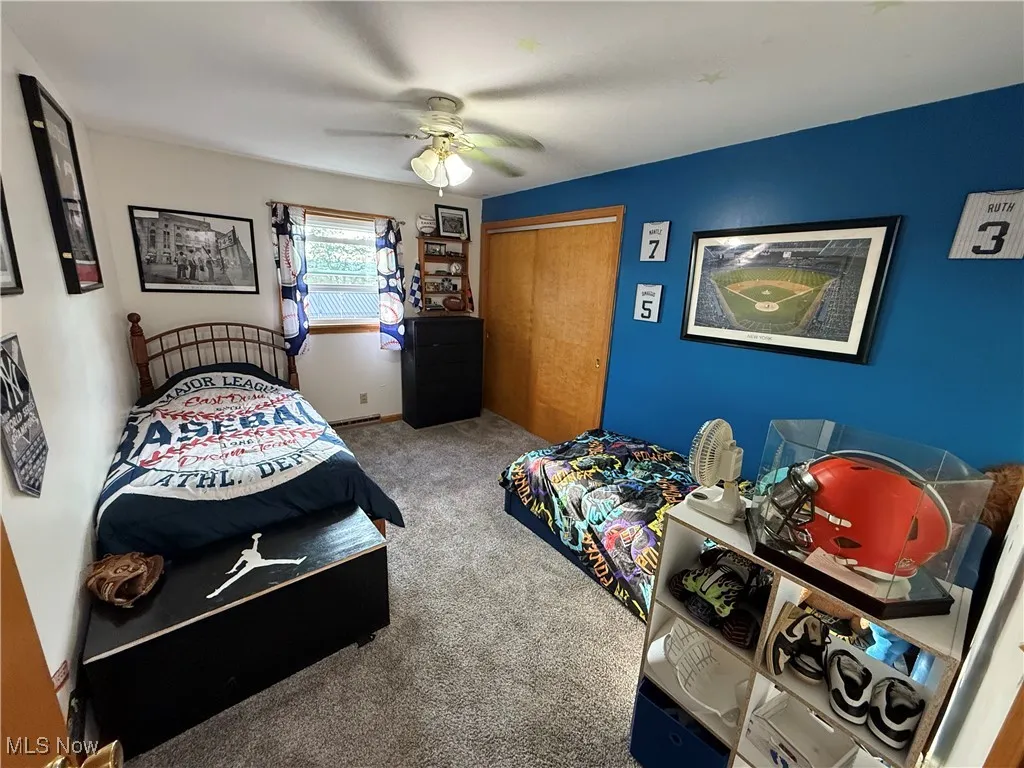 Bedroom with carpet floors, a closet, and a ceiling fan
