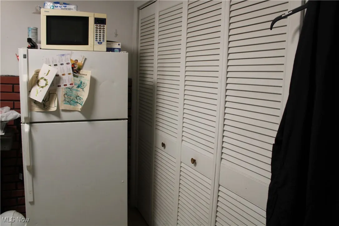 Kitchen featuring white appliances in beauty shop
