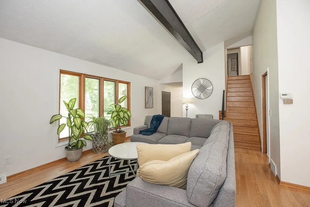 Living area featuring stairs and light wood-type flooring