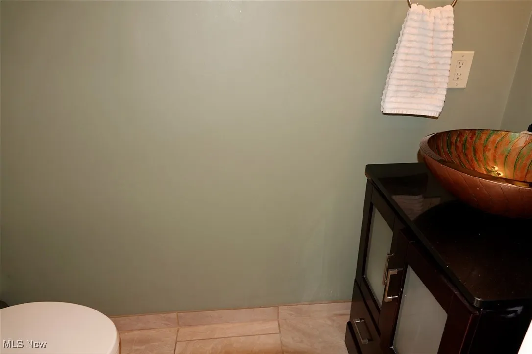 Bathroom featuring toilet and light tile patterned flooring