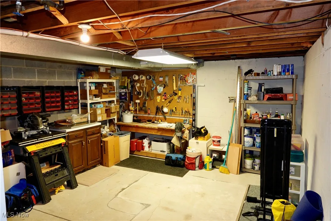 Unfinished below grade area featuring a workshop area