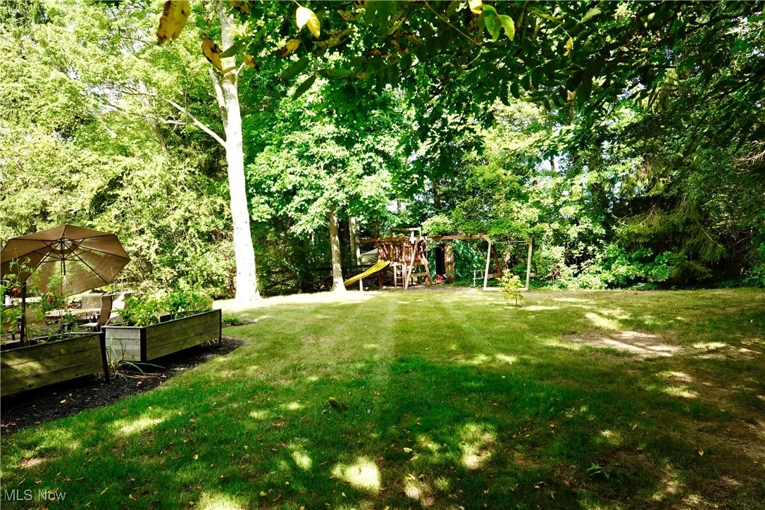 View of grassy yard with a playground
