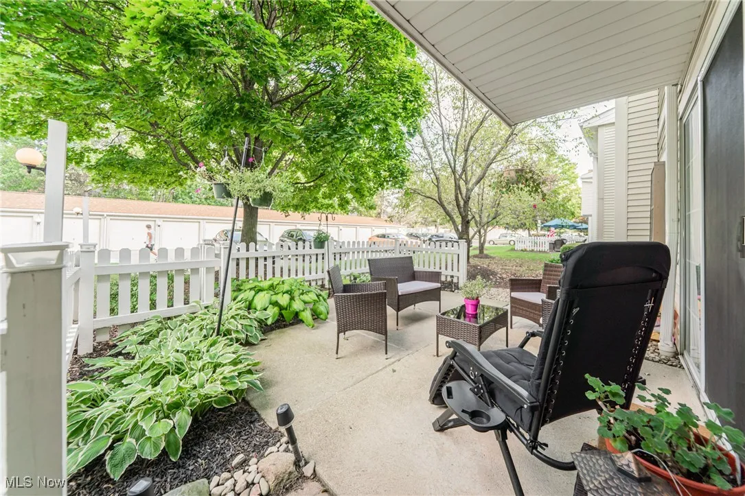 Fenced backyard featuring a patio, an outdoor hangout area, and a grill