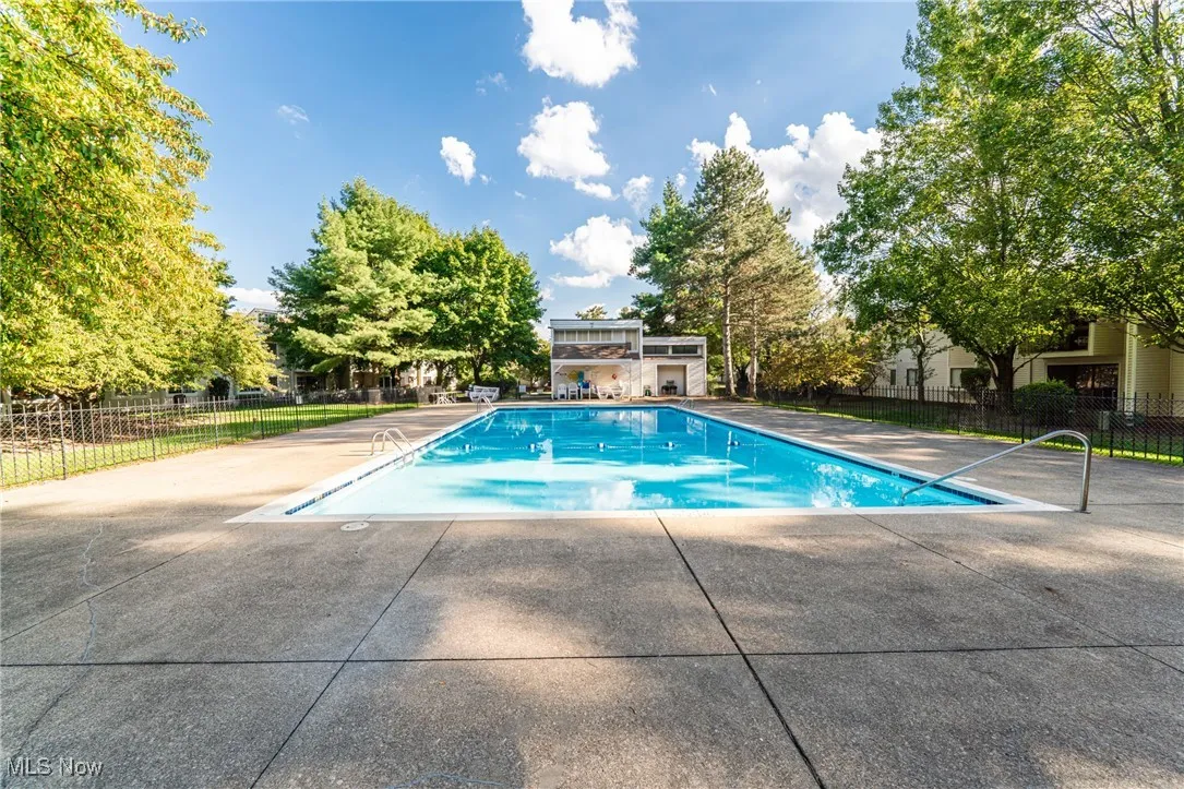 Community pool featuring a patio