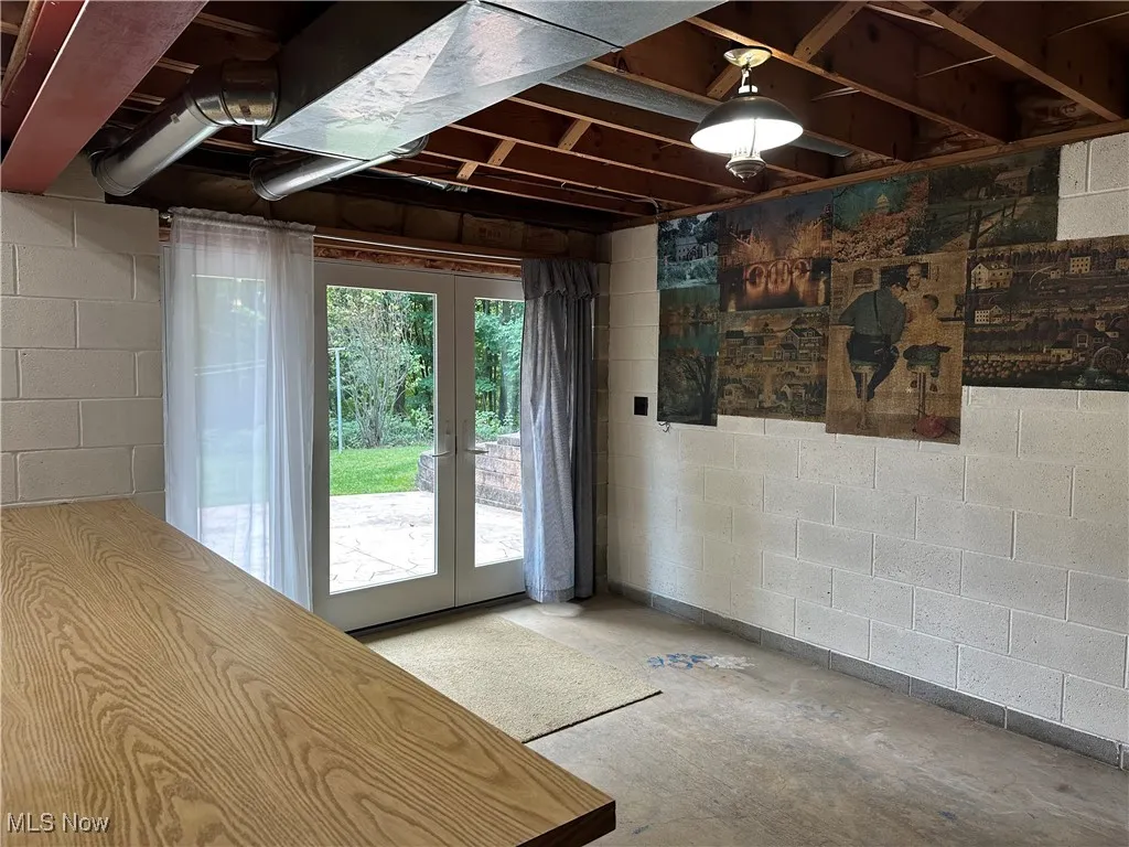 Doorway to outside featuring concrete flooring and french doors