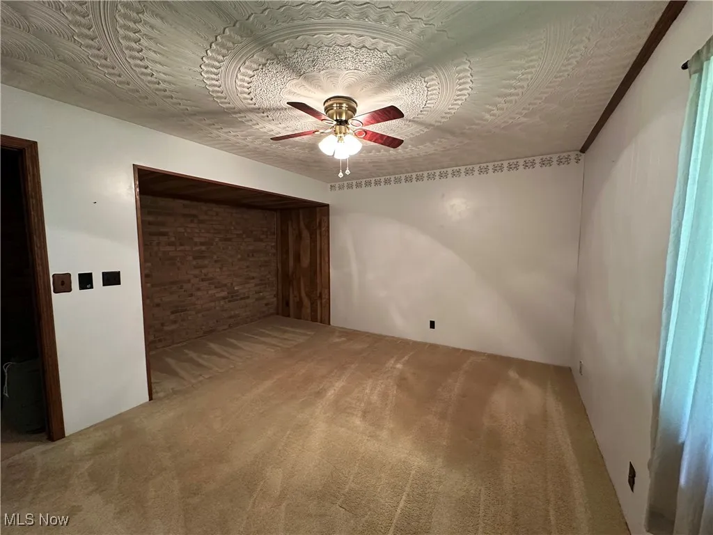 Unfurnished bedroom with carpet flooring and a ceiling fan