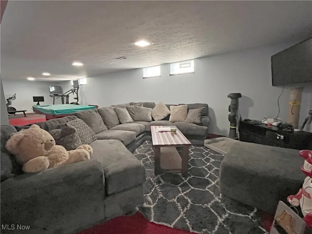 Living room featuring billiards table and a textured ceiling