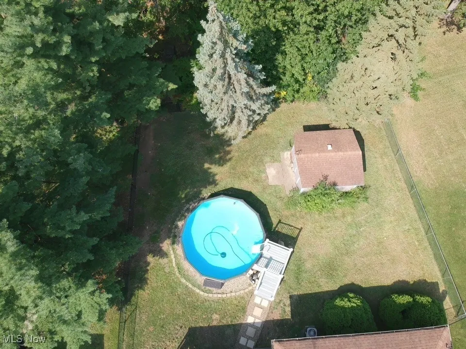 Aerial view of property's location with a pool