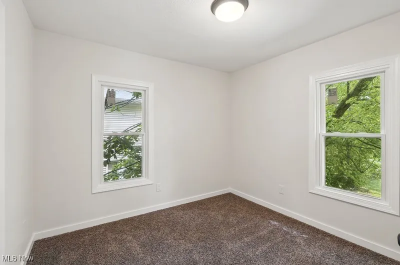 Carpeted empty room with plenty of natural light