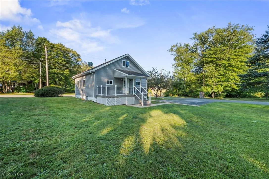 View of front of property with a front lawn and a porch