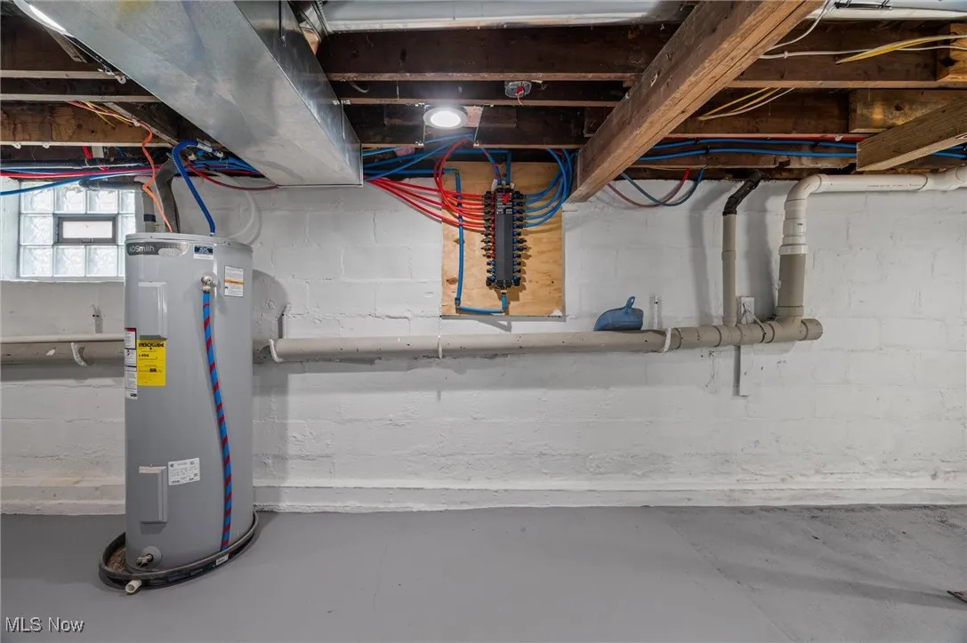 Below grade area featuring water heater