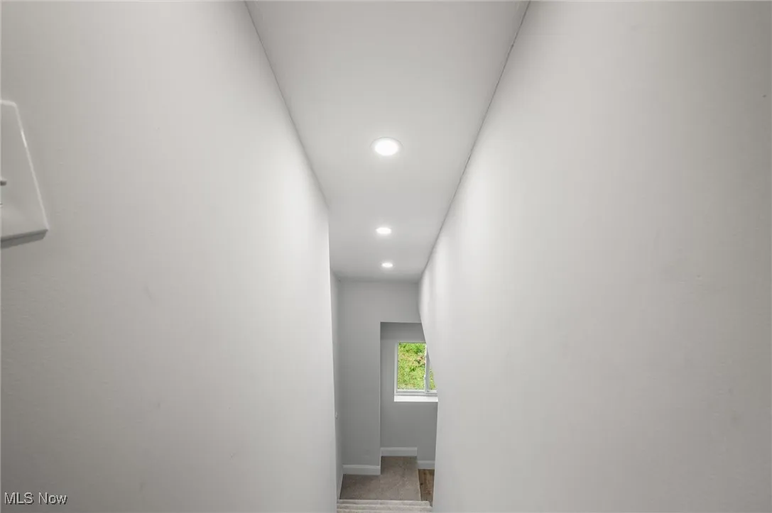 Hall featuring recessed lighting and baseboards