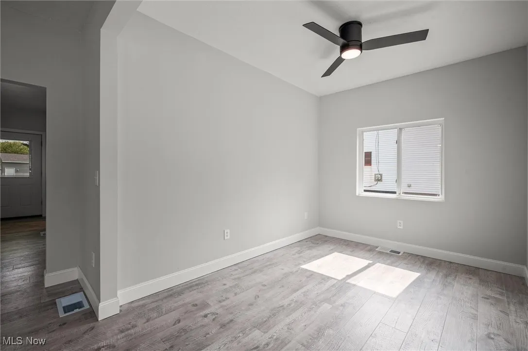 Spare room with light wood-style floors and ceiling fan
