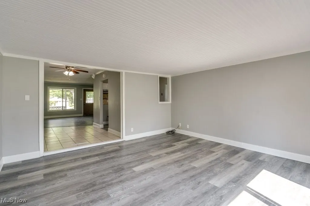 Empty room featuring light wood-style floors and ceiling fan