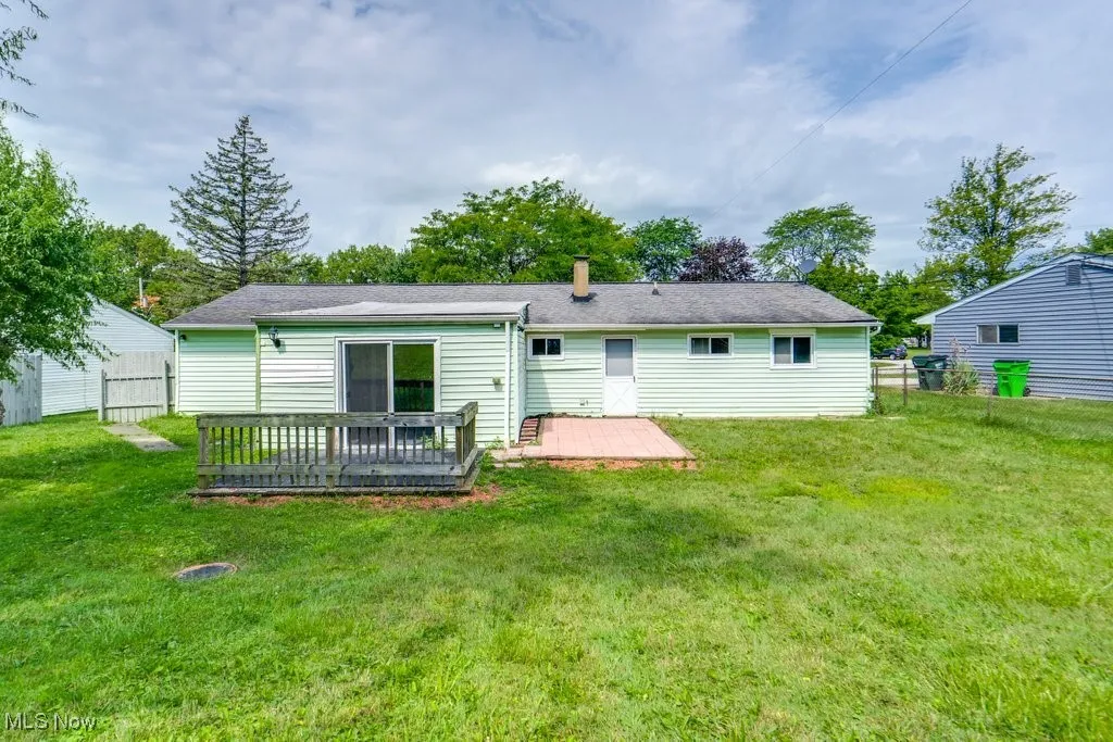 Back of house featuring a wooden deck