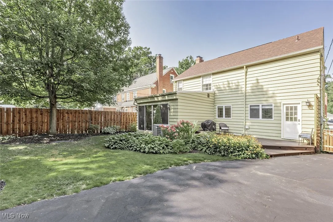 Private fully fenced in and professionally landscaped backyard with deck.