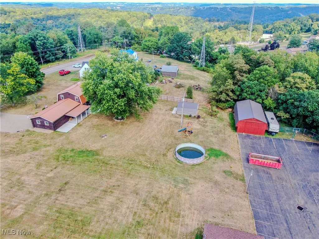 Aerial view showing back yard and outbuildings
