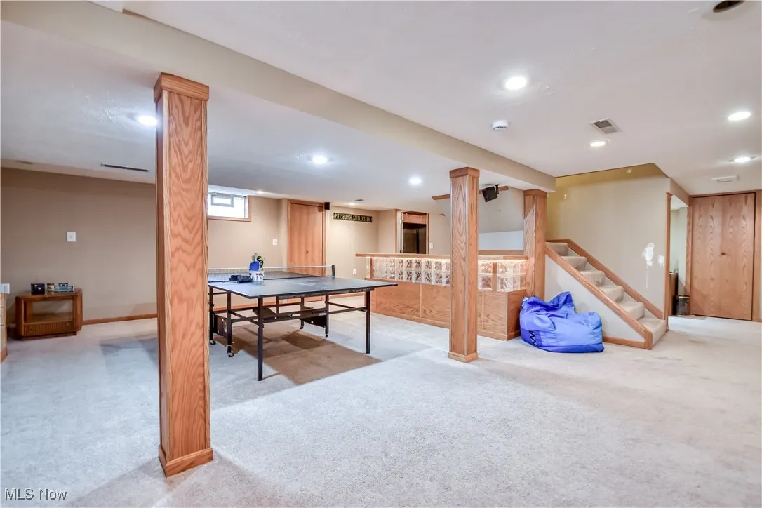 Rec room with light colored carpet and recessed lighting