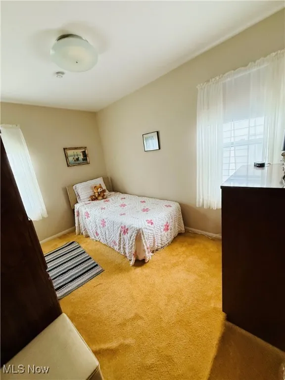 Carpeted bedroom with baseboards