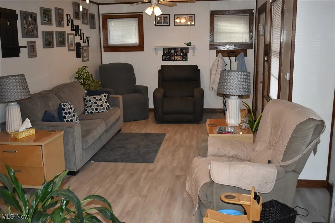 Living area featuring wood finished floors and ceiling fan